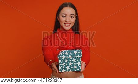 Positive Smiling Pretty Woman Presenting Birthday Gift Box Stretches Out Hands, Offer Wrapped Presen