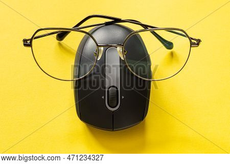 Anthropomorphism Concept. Computer Mouse With Glasses On Yellow Background. Internet Search With Low