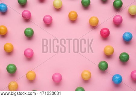 Many Bright Chewy Gumballs On Pink Background, Flat Lay. Space For Text