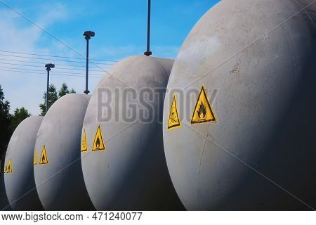 Large Gray Tanks With Dangerous And Poisonous Cargo Stand Outside In Open Storage Warehouse. Industr