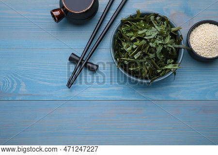 Fresh Laminaria (kelp) Seaweed Served On Light Blue Wooden Table, Flat Lay. Space For Text