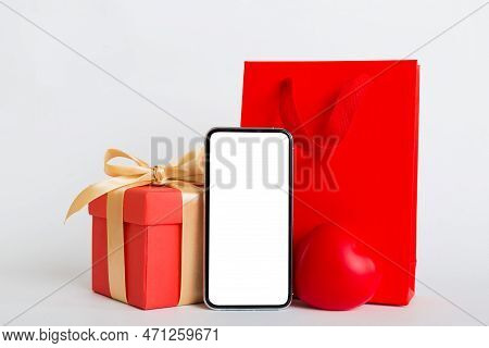 Mobile Phone With Blank Screen On Colored Background With Hearts, Calendar And Gift Box, Valentine D