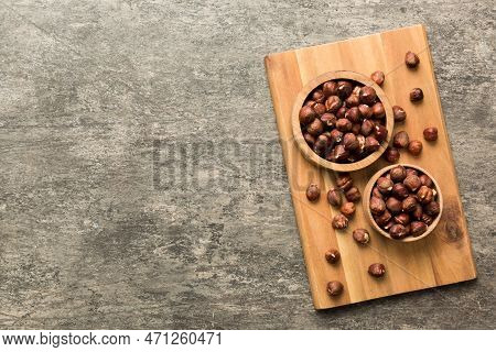 Wooden Bowl Full Of Hazelnuts On Table Background. Healthy Eating Concept. Super Foods.