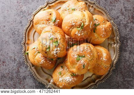 Homemade Buttery Garlic Knot Bread With Parsley And Parmesan Cheese And Dried Greens Closeup On The 