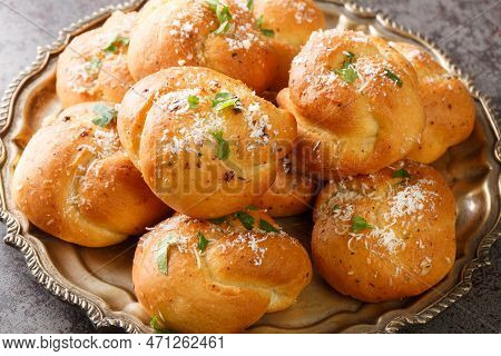 Homemade Buttery Garlic Knot Bread With Parsley And Parmesan Cheese And Dried Greens Closeup On The 