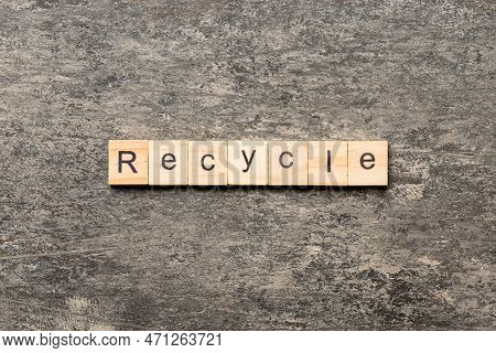 Recycle Word Written On Wood Block. Recycle Text On Cement Table For Your Desing, Concept.