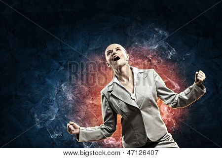 businesswoman in anger screaming against dark blue background