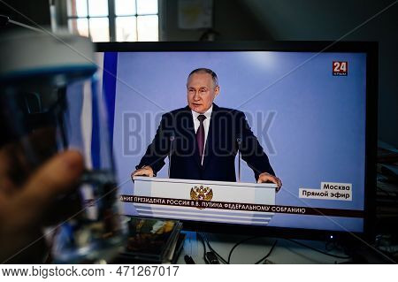 Paris, France - Feb 21, 2023: Man Watching On Pc Krym 24 Station Direct Stream Drinking Water As Rus