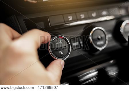 Closeup Of Hand Adjusting The Conditioner In A Modern Car. Dashboard With Air Flow, Climate Control 