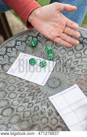 Two Friends, Men And Women Are Playing Yamb Game In Their Free Time In The  Spring Garden