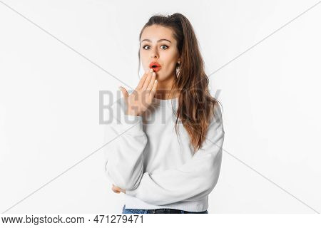 Ouch. Amazed Young Woman Showing Oops Expression At The Camera. Portrait Of Young Girl With Long Hai