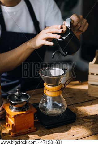 Professional Barista Preparing Coffee Using Chemex Pour Over Coffee Maker And Drip Kettle. Alternati