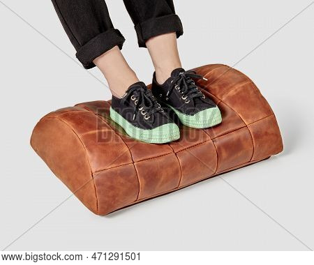 Female Feet Resting On Comfortable Terracotta Leather Footstool Cushion