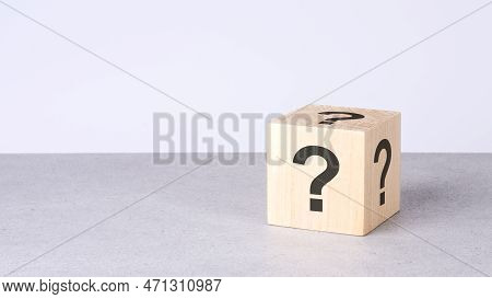 Natural Wooden Cube With Question Mark On Grey Background