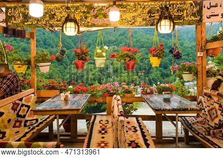 Masuleh, Iran - May 2022: Beautiful Flower Decorations In Cafe With Seats In Masouleh Village.