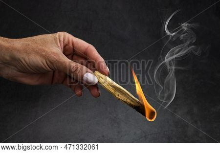 Palo Santo Burning In Front Of Dark Background
