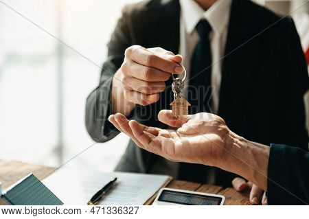 Buying A Home Or Insurance Deal, An Insurance Agent Pointing A Pen To Those Interested In Renting A 