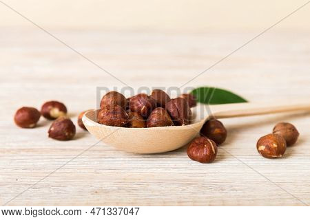 Wooden Bowl Full Of Hazelnuts On Table Background. Healthy Eating Concept. Super Foods.
