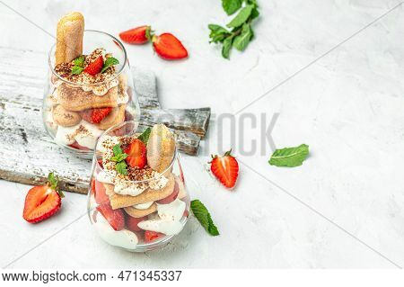 Tiramisu. Homemade Tiramisu With Fresh Strawberry, Mascarpone And Mint In Glass On Light Background.