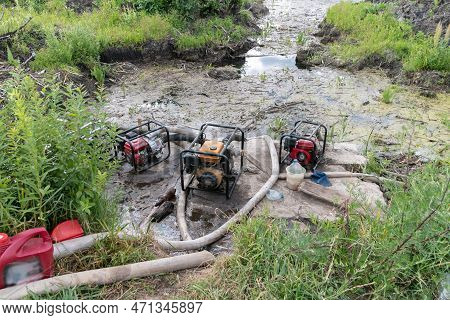 Water Pumps Pump Water From The Pond. Drainage Of A Reservoir, Swamp, Lake With The Help Of High Pre
