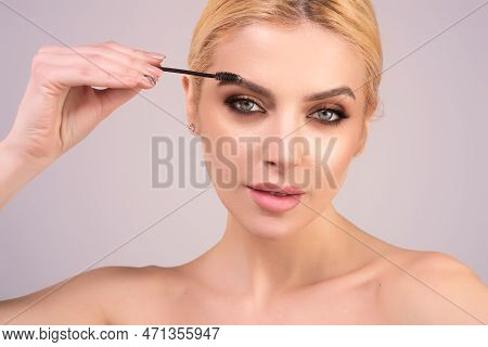 Eyebrow Shaping, Woman Combs Eyebrows With A Brus. Eyebrow Line. Makeup And Cosmetology Concept. Fem