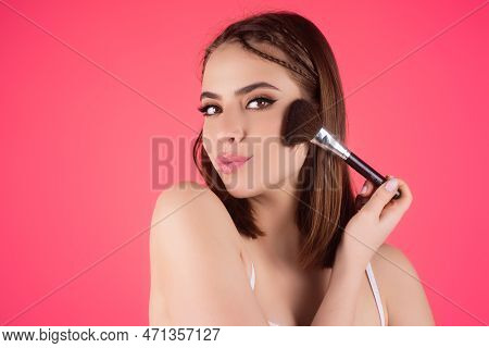 Young Woman Applies Powder On The Face Using Makeup Brush. Beautiful Girl Doing Contouring Apply Blu
