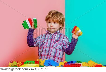 Little Boy Playing With Lots Of Colorful Plastic Blocks Constructor. Boy Playing With Construction B