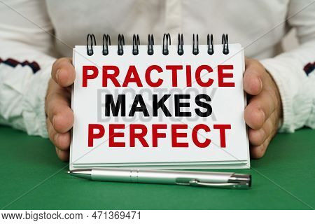 A Man Holds A Notepad In His Hands With The Inscription - Practice Makes Perfect.