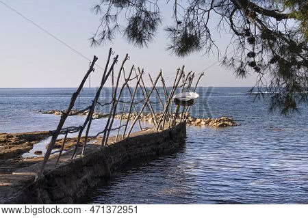 An Old Boat Pulled Ashore On A Characteristic Wooden Structure In Savudrija, Croatia
