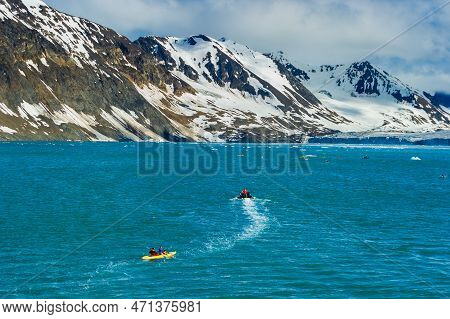 A Raft And Toutists In Inflatable Kayaks In The Arctic Ocean, Hornsund, Norway