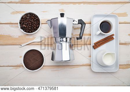 Cup Of Coffee, Geyser Coffee Maker And Coffee Beans On ,white Wooden Table. Top View.