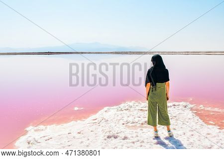 Caucasian Woman Tourist Stand On Maharlu Pink Salt Lake Shore. Travel Destination Iran In Shiraz