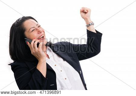 Happy Adult Businesswoman Celebrating Victory With Fist Hand Gesture While Making Phonecall As Corpo
