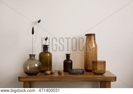 Vintage And Cozy Interior Of Living Room Space With Wooden Consola, Glass Vase With Dried Flowers, B