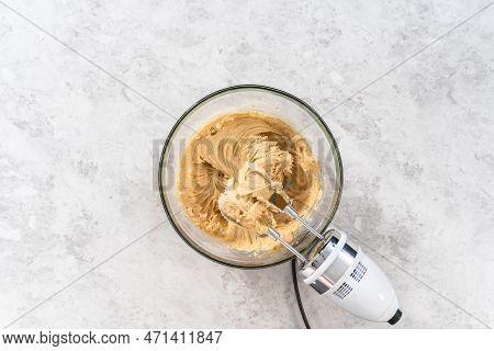 Flat Lay. Mixing Ingredients In A Large Glass Mixing Bowl To Bake Eggnog Scones.