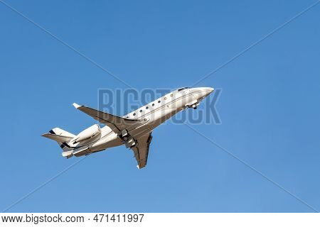 Scenic Close Bottom View Modern Luxury Expensive White Private Jet Plane Dispatching From Airport Is