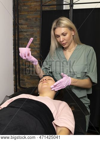 Acne Treatment, Young Skin Care. Cosmetologist Does Alginate Mask Procedure On Female Teen Face. Tee