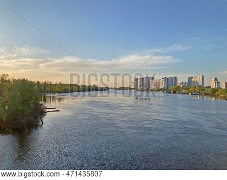 Beautiful Panoramic View Of The City Of Kyiv Dneper River At Sunset On Dark Blue Water With Glowing 