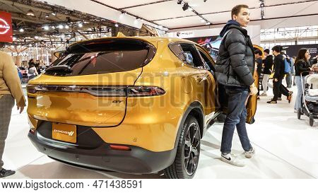 Close Up View Of Yellow Dodge Gt Car On Display. Crowds Looking At New Car Models At Auto Show. Nati