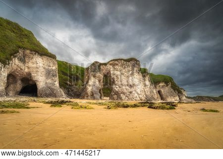 Panorama With White Limestone Rock Formations And Sandy Beach On Beautiful Causeway Coast And Wild A