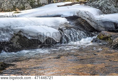 Water  Flowing Over Rocks  In  Frozen Willard Brook In Ashby Massachusetts,
