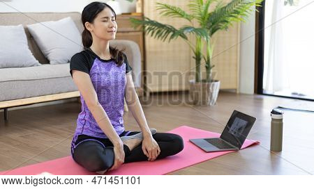 Beautiful healthy woman practicing yoga, Stretch or warm up before exercising, Calming the mind and 