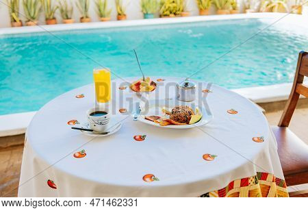 Traditional Breakfast Served At The Table Near A Swimming Pool. Breakfast Served On The Table With A