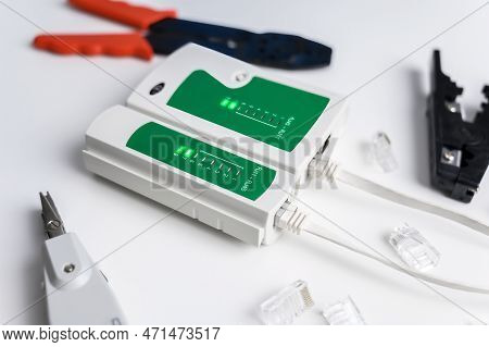 Cat6 Rj45 Cable Network Tester. Twisted Pair Test Tool On The Desktop.