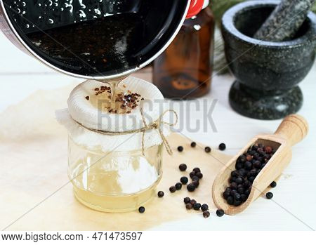 Alternative Medicine, Filtering Juniper  Ointment. Medicinal Cream From Dried Common Juniper Berries