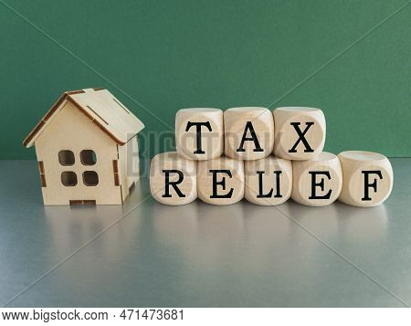 Tax Relief Symbol. Concept Words 'tax Relief' On Wooden Blocks On A Beautiful Green Background. Busi