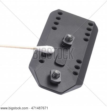 Cotton Swab Cleaning A Bipod Mounting Plate For A Rifle Isolated On White