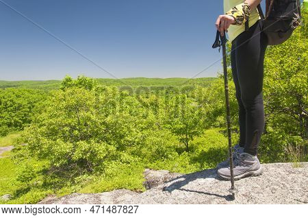 A Waist Down Picture Of A Woman Hiker With Trekking Pole On Top Of A Rocky Summit Of Stone Man Mount