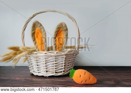 Easter Eggs And A White Basket With Rabbit Ears