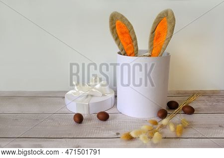 Easter Eggs And A White Basket With Rabbit Ears